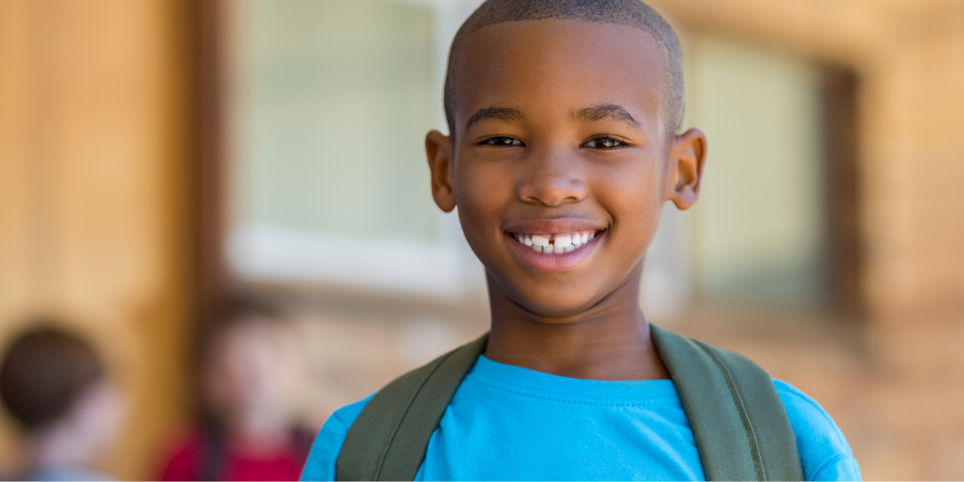 Board Member hands out shoes to little boy